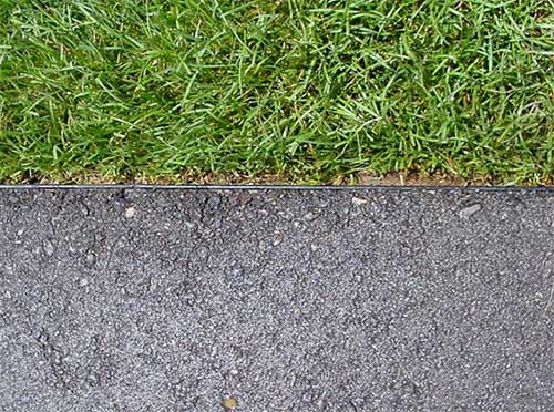 asphalt driveway edging installed next to grass