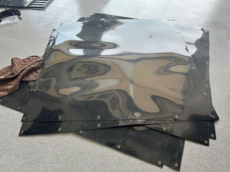 Stack of HDPE dog kennel divider panels with grommets
